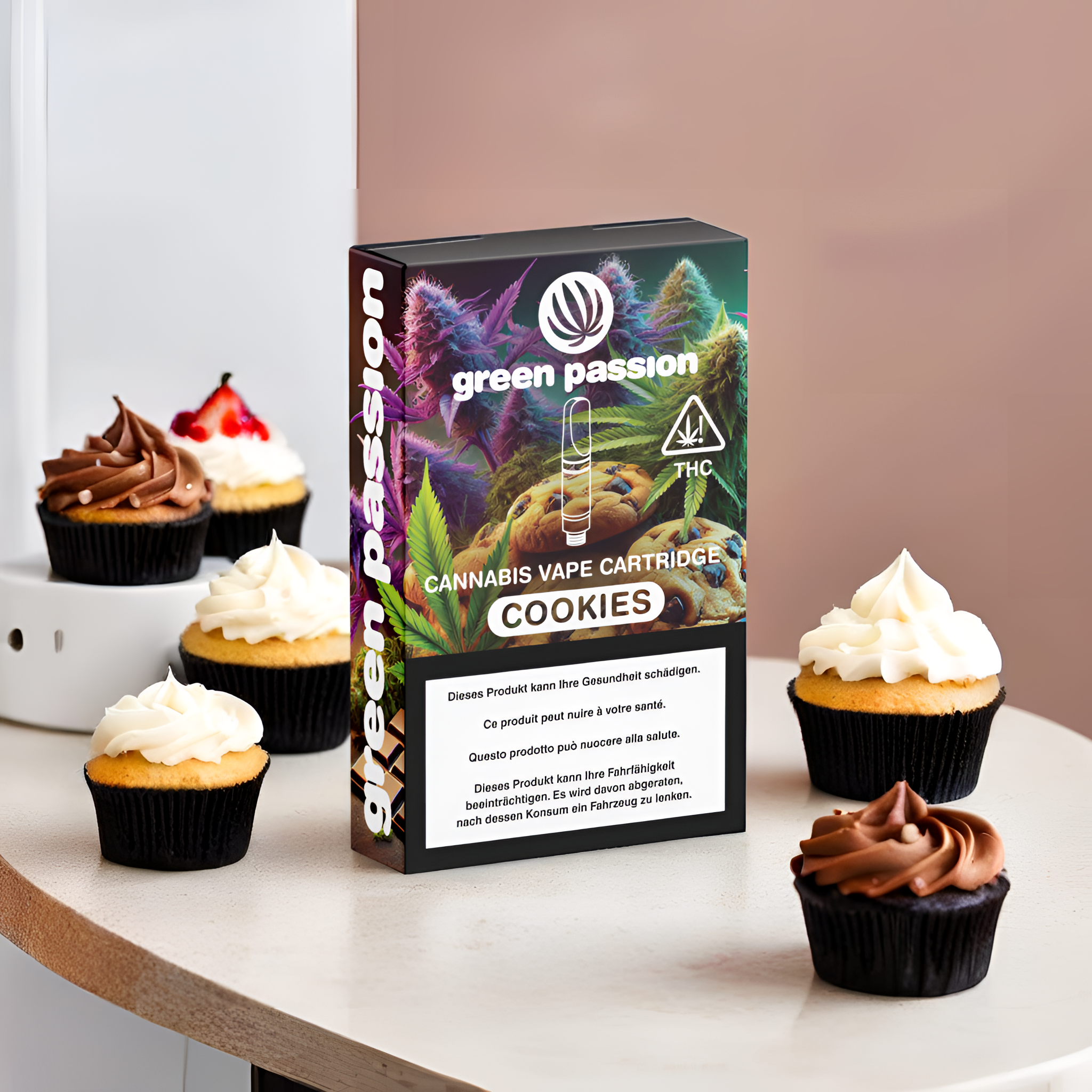 CBD Vape Cartridge Cookies de Green Passion sur une table avec des cupcakes – image d’ambiance sucrée et ludique pour la boutique en ligne Suisse
